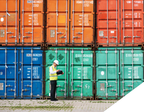 Man standing in front of colorful cargo containers